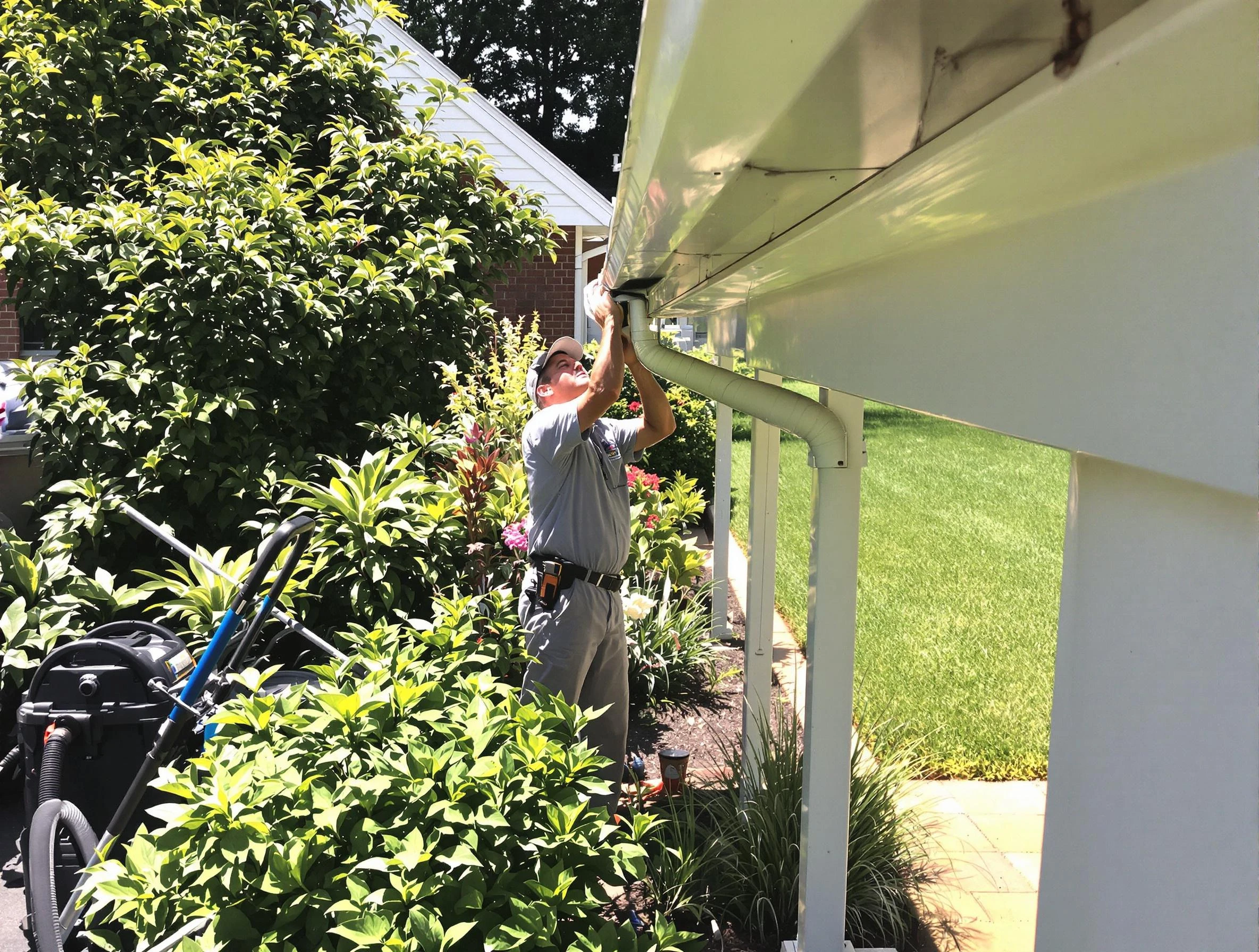 Technician flushing a blockage from a downspout in Barberton, OH